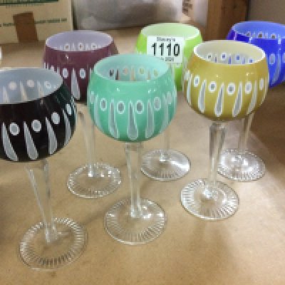 A collection of six coloured wine glasses and three others .