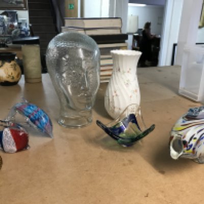 A Collection of ceramics including a glass head, Wedgwood vase and fish figures . This lot cannot be posted