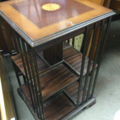 An inlaid mahogany revolving bookcase. Shipping category D.