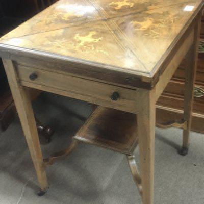 An Edwardian inlaid Rosewood envelope card table the quterd top inlaid with classical urns. NO RESERVE