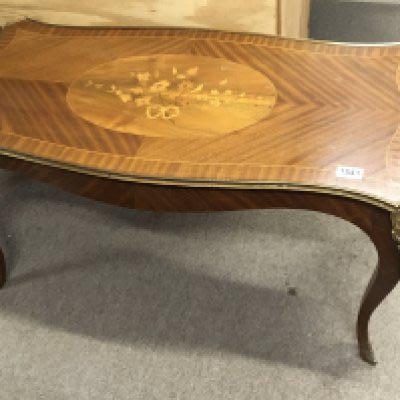A French style inlaid walnut occasional table with a shaped top and floral motif with applied gilt metal mounts.NO RESERVE
