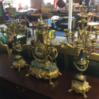 A 20th Century French style clock garniture decorated with unusual cloven footed cherubs. Shipping category D.