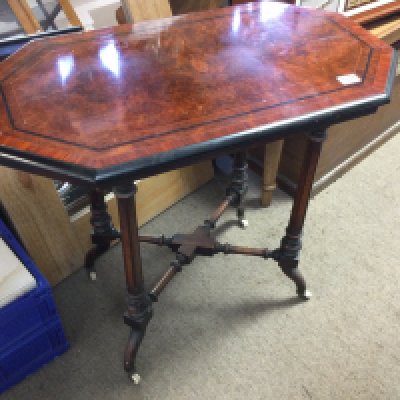 A Victorian burr walnut occasion table the fluted legs United by stretchers .