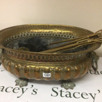 A 19th century Continental brass wine cooler the sides with lion masks and claw feet a set of fire irons and one other silver plated cooler with detachable liner. 59cm