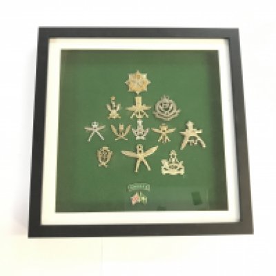2 cased military collections. One case includes a series of Gurkha British army unit medals, the other includes a wide variety of British army uniform buttons.