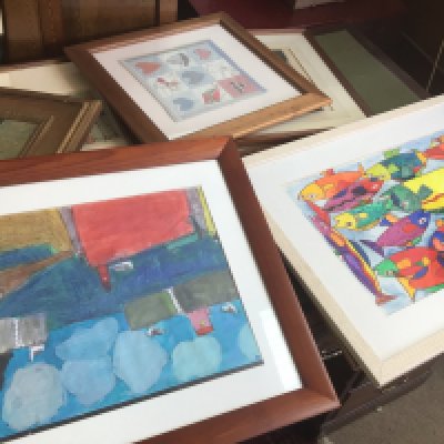 A collection of framed prints including abstract, town scenes etc
