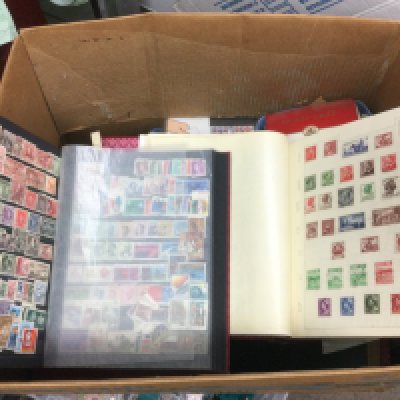 A box of mixed world stamps, loose and in binders. Shipping category D.