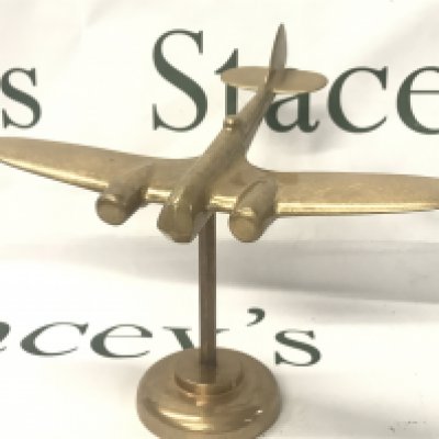 A solid brass aeroplane and stand , postage category B