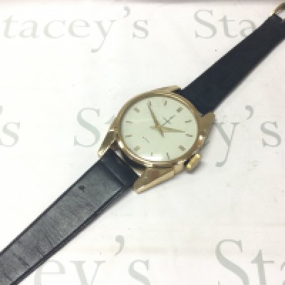 A c1960 towncraft brass and leather wall clock/ watch , 2 jewels , seen working.