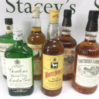 Six bottles of Whiskey and gin comprising two 1 litre bottles of Southern Comfort, Gordon's Gin etc. Shipping category D.