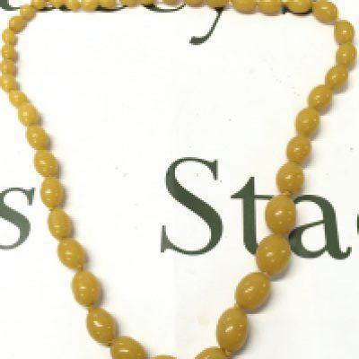 A butterscotch bakelite amber necklace , 80cm long, 100g total weight. Postage category A