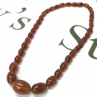 A graduated bakelite amber necklace , 54cm long. 35g total weight. Postage category A