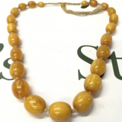 A butterscotch bakelite amber necklace , 105g total weight 62cm long. Postage catA