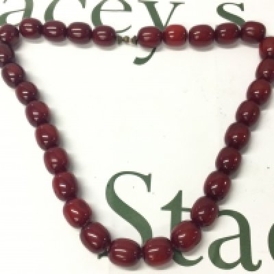 A cherry amber Bakelite necklace , 145g total approx weight. 67cm total length. postage category A