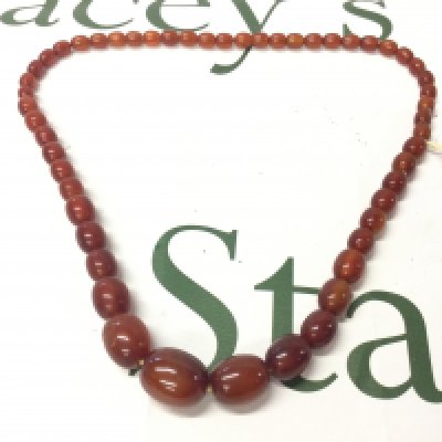 A Bakelite amber necklace , 60cm long . 45g approx weight. Postage catA
