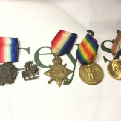 First World War medals awarded to N.G.Preddy CH STO R N along with two silver cap badges. Postage B