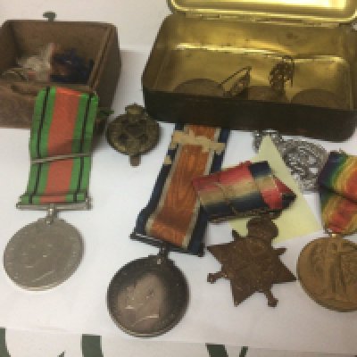 A group of I world war medals including 1914/15 star awarded to 18715 Pte J G Brown Devon R a II world war medals other military badges a Christmas tin and other oddments.