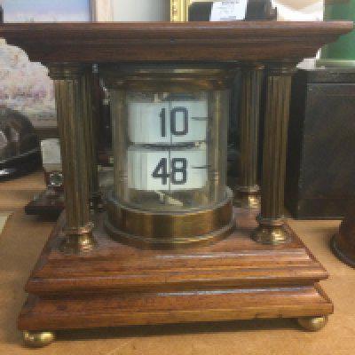 A mahogany case flip ticket clock .