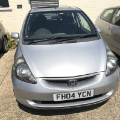A silver Honda Jazz 1.4SE 5 door automatic. Registration number is FH04 YCN. Mileage 79877. 3 owners. Lasted service carried out in 20th March 2024 and extensive service details on prior services carried out. MOT until 3rd April 2026. Bodywork damage to front by bumper on passenger side and rear passenger door.