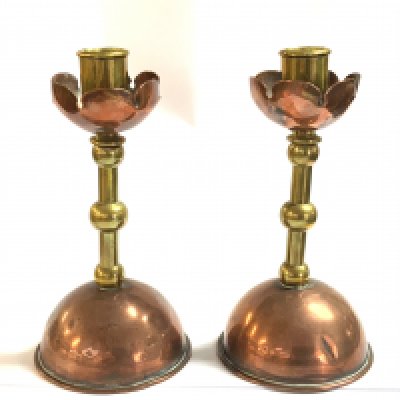 A Pair of Arts and Crafts copper and brass candlesticks in the manner of Christopher Dresser. 19cm.