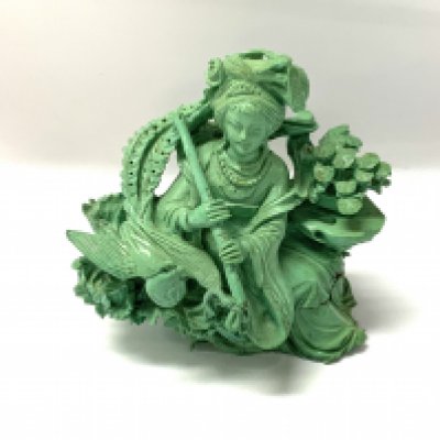 A 20th Century carved turquoise figure of a flute player and pheasant. 9cm.