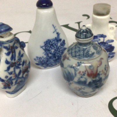 An interesting Chinese porcelain scent bottle with revolving central sections the sides decorated with figures and underglaze iron red with blue Caricature marks to the base and three other blue and white Chinese porcelain scent bottles. (4). NO RESERVE
