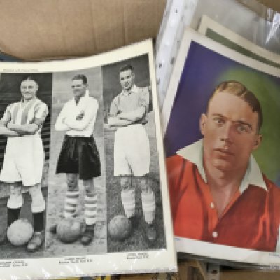 A box containing ephemera including some first issue comics TV Help issue one Vintage Topical Times football players Vintage Champion and lots of other ephemera.