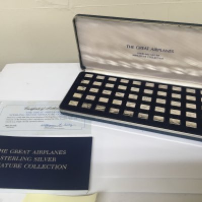 A presentation case containing miniature silver ingots The Great Airplanes collection fifty ingots with certificate of authenticity and references book.