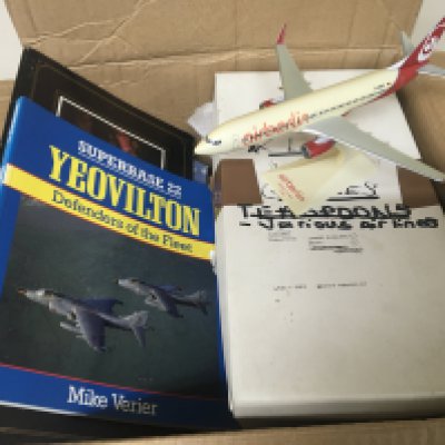 A box containing Aircraft memorabilia including books on U.K. airports commercial Airline glasses and cutlery an air Berlin model and other items.