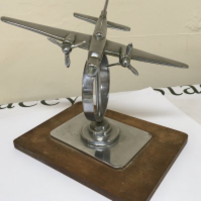 A 1930 Chrome desk top model of an Aircraft with double propeller.