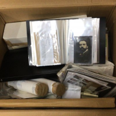 A box containing a collection of postcard albums posters prints and other ephemera.